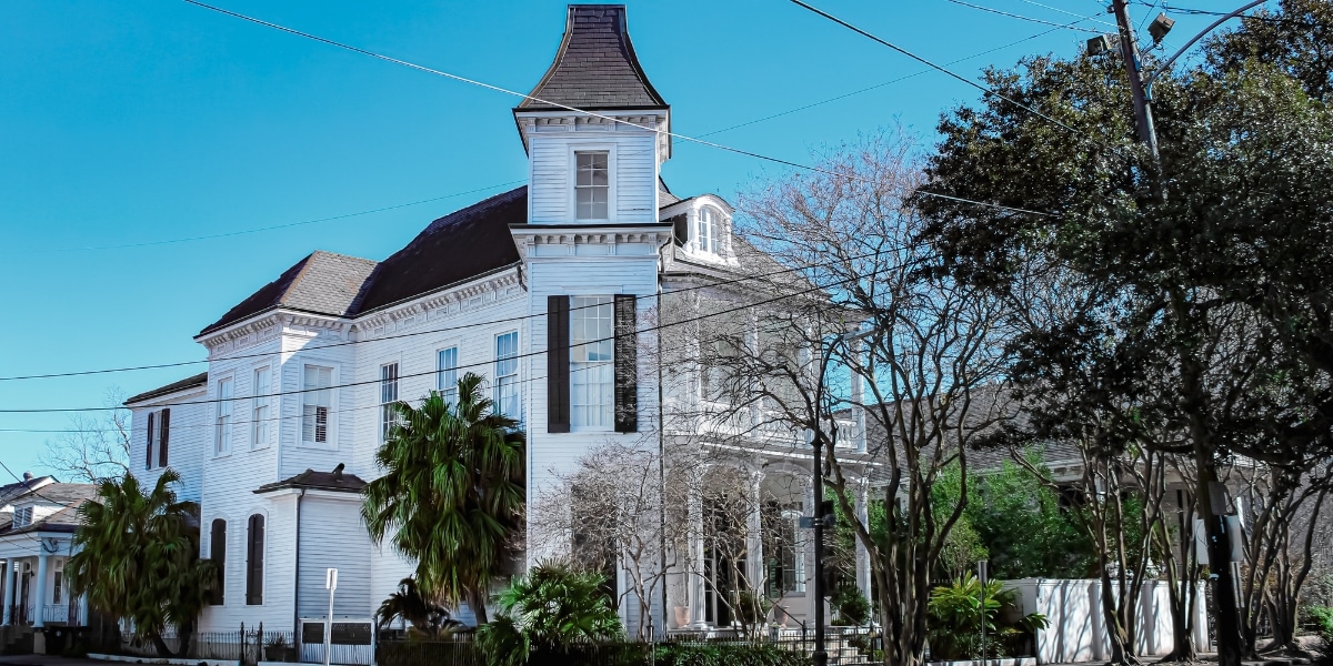 A historic New Orleans residence with intricate rooflines, showcasing its restoration potential.